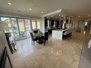 A spacious kitchen with a central island, large windows, and a view of the outside. - Luxury 2 story condo on beautiful Lake Washington close to Downtown Kirkland (Kirkland)