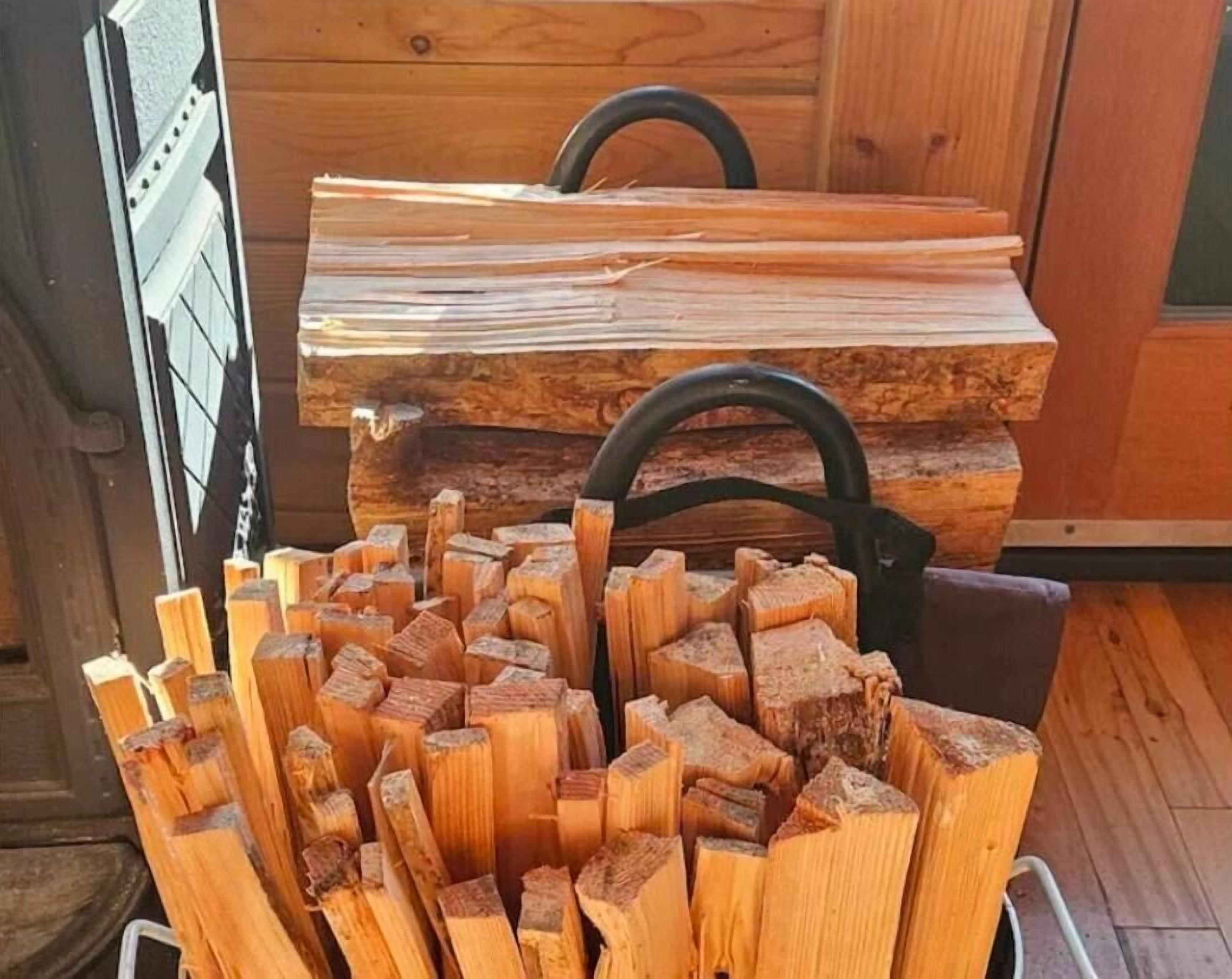 A pile of cut wood logs in a wooden cabin.