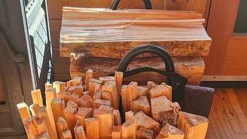 A pile of cut wood logs in a wooden cabin.