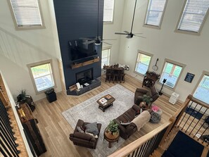 A spacious living room with a fireplace, comfortable seating, and a television. - Lake Cumberland Lake House! We would love to share our retirement home with you! (Monticello)