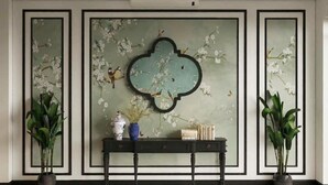 A lobby with a decorative wall, a ceiling fan, and a patterned floor. - Charming Moon Hotel (Hanoi)