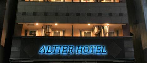 A multi-story building with a sign reading "ALTIER HOTEL".
