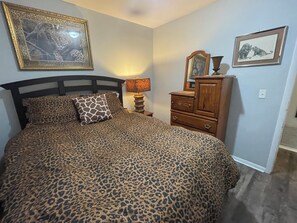 A bedroom with a bed, a nightstand, a dresser, and two framed pictures on the wall. - Aimee's Place- Comfy and  Close to Everything! (Moore)