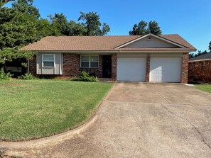 A single-story brick house with a front garage and a well-maintained lawn. - Aimee's Place- Comfy and  Close to Everything! (Moore)