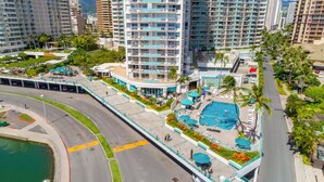 A high-rise hotel with a rooftop pool, multiple balconies, and a landscaped terrace. - @ Marbella Lane - Cozy 2BR w/ Amazing Ocean Views (Honolulu)
