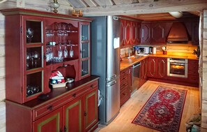A kitchen with wooden cabinets, a stainless steel refrigerator, a microwave, and an oven. - Gorgeous home in Gålå with house a mountain view (Gålå)
