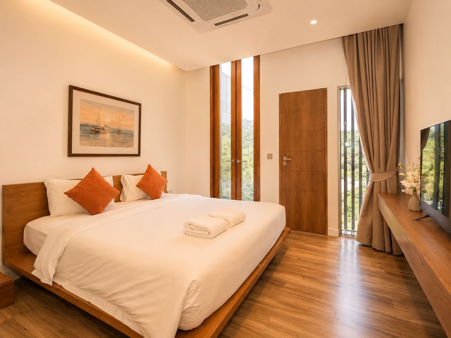 A modern bedroom with a large bed, a painting on the wall, and a view through the window.