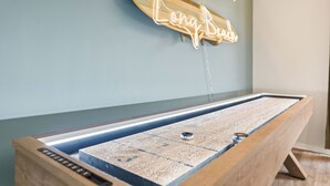 A pool table with a neon sign reading "Long Beach" and a wooden skateboard. - Vibrant 2-bedroom guest house with AC in Long Beach near Retro Row (Long Beach)