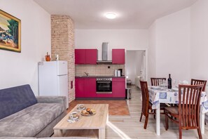 A compact living space with a kitchenette, dining area, and a sofa. - Pool Apt 3 - Novi Vinodolski (Ground), Novi Vinodolski, Croatia (Novi Vinodolski)