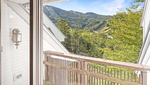 A balcony with a view of a mountainous landscape.
