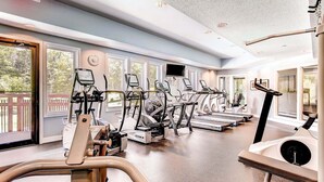 A gym with treadmills, ellipticals, and a rowing machine.