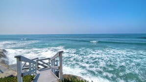 A staircase leading to a beach with ocean views.