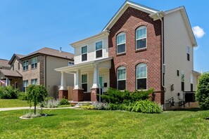 A two-story house with a front porch, brick exterior, and a well-maintained lawn. - 3229 Eads Ave (St. Louis)
