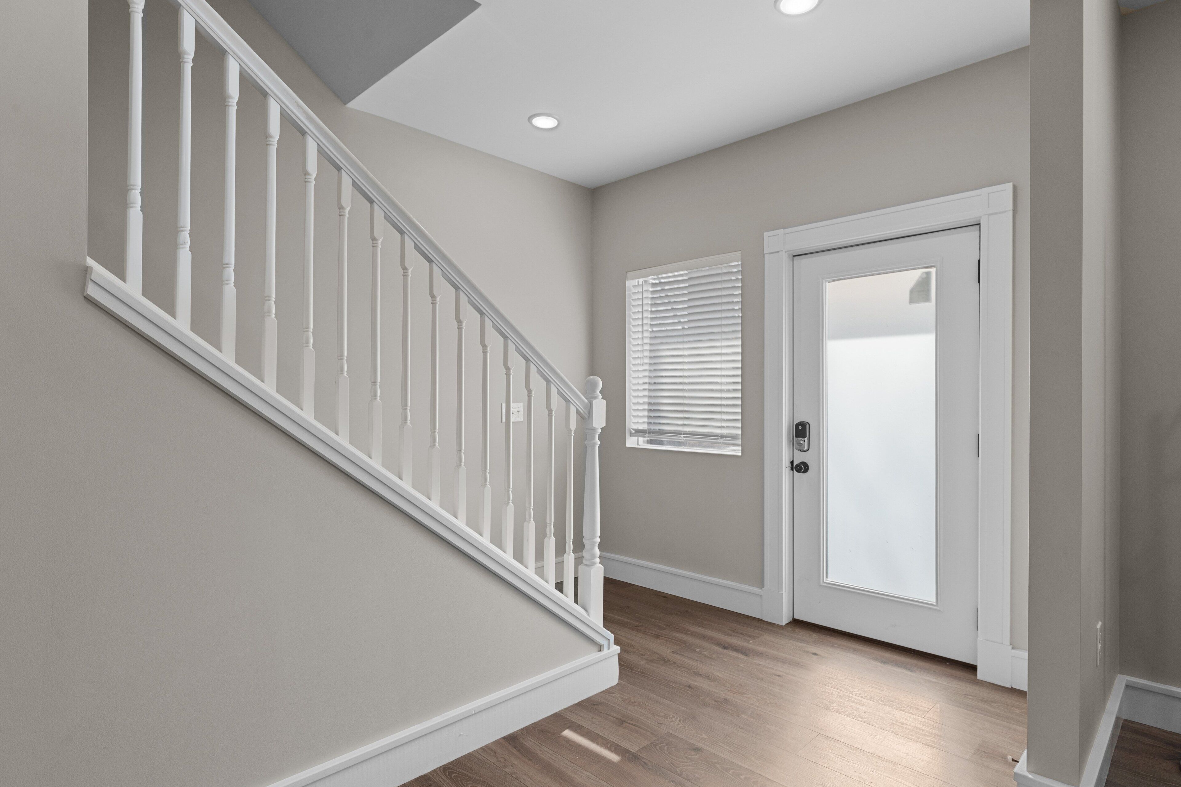 A staircase with white balusters leading to a landing.