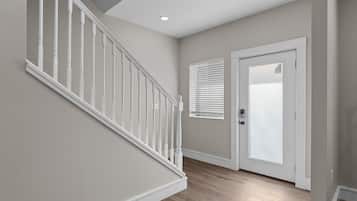A staircase with white balusters leading to a landing.