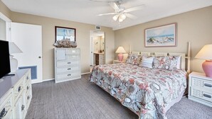 A bedroom with a bed, dresser, ceiling fan, and artwork on the walls. - Anchorage Resort 3rd Floor 2 Bedroom Condo South West Balconies 0885 (Siesta Key)