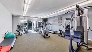 A gym with cardio machines, weight training equipment, and a yoga ball. - Anchorage Resort Siesta Key 6th Floor 2 Bedroom Condo Beach Access 0890 (Siesta Key)