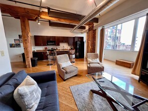 A modern living room with a sofa, armchairs, and a glass coffee table. - Fancy (Nashville)