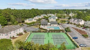 A residential area with multiple houses, a tennis court, and a swimming pool. - Putters Hideaway @ Legends Golf Resort (Myrtle Beach)