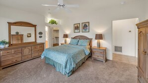 A bedroom with a bed, dresser, nightstands, and a ceiling fan. - Santa Susana (Sedona)