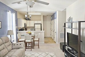 A compact living space with a dining area, kitchenette, and a TV area. - Hidden Haven by WT Golf Peaceful 2BR Condo (Myrtle Beach)