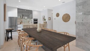 A modern kitchen with white cabinets, a stainless steel refrigerator, and a built-in oven. - Villa Granada by Rove Waterfront W/pool, Hot Tub (Miami)