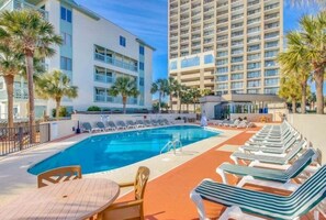 A hotel pool area with lounge chairs and a pool. - Ocean Forest Plaza Unit 1412 (Myrtle Beach)
