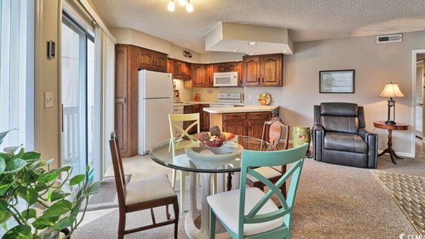 A compact living space with a kitchen, dining area, and seating area. - Cypress Bay Getaway (Little River)