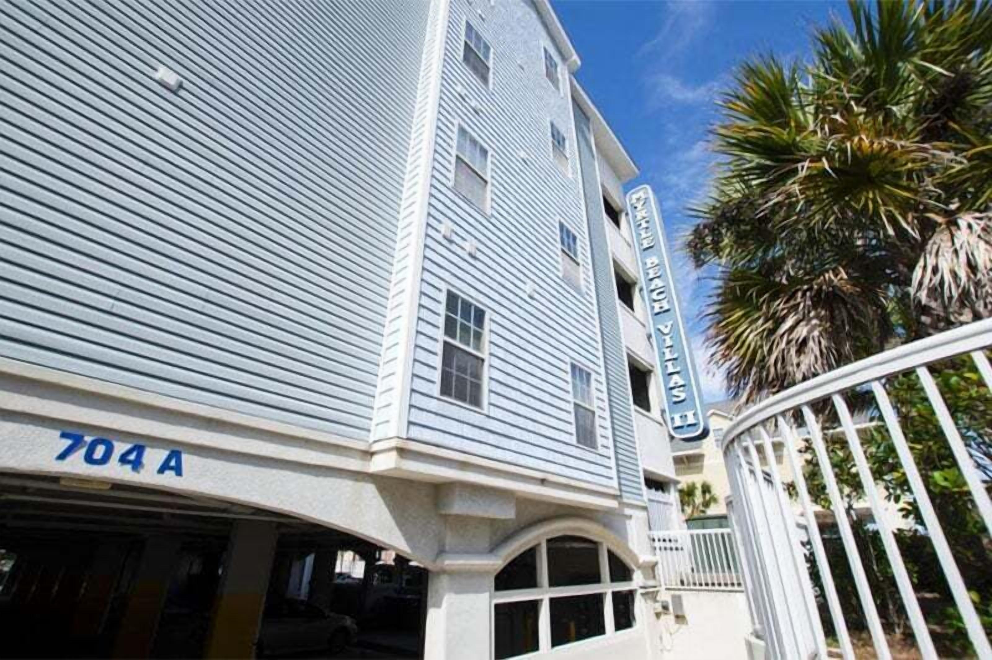 A two-story building with a sign reading "704A" and "Beachside Villas."