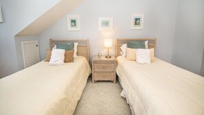 A bedroom with two beds, a nightstand, and a ceiling fan. - West Hyde Park 2E (Myrtle Beach)