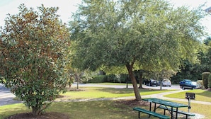 A park with a picnic table and a tree. - Heatherstone 1063 (Myrtle Beach)