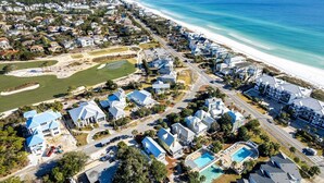 An aerial view of a coastal residential area with houses, a golf course, and a beach. - Little Wing (Santa Rosa Beach)