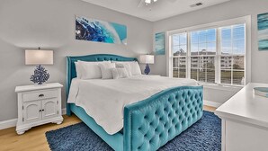 A bedroom with a large bed, a ceiling fan, and a window with blinds. - Magnolia Pointe Magnolia Lake 4820-303 (Myrtle Beach)