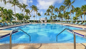 A pool with lounge chairs and palm trees. - Waterfront Luxury Villa With Sunset Views and Boat Slip (Marathon)