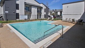 A rectangular swimming pool with a metal ladder, surrounded by a concrete deck. - Modern&beautiful,pool,a+ Location,longstaydiscount (Sherman)