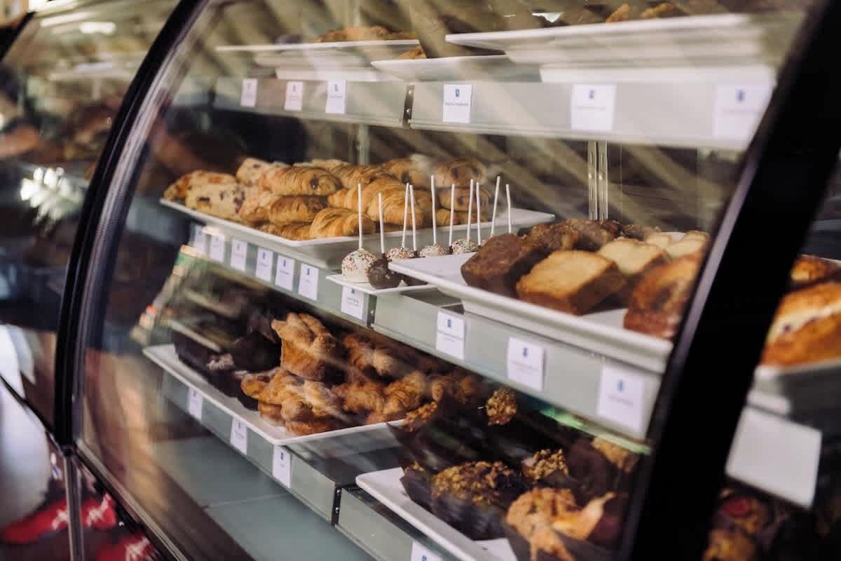 A bakery display case with various baked goods.