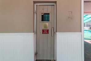 A door with a sign that says "DO NOT TAKE WATER IN SAUNA." - Heron Pointe C12 (Myrtle Beach)