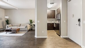 Eine moderne Wohnung mit Wohnzimmer, Küche und Flur.