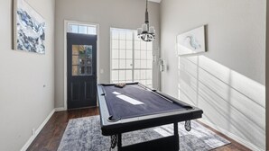 A pool table in a room with a door, windows, and artwork on the walls. - Luxe 3B 5B Cozy, Spacious Home, 5-star Stay in Frisco (Frisco)