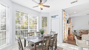 A dining area with a table, chairs, and a ceiling fan. - Bright & Cozy 4BR Home w Movie Room & Backyard (Frisco)