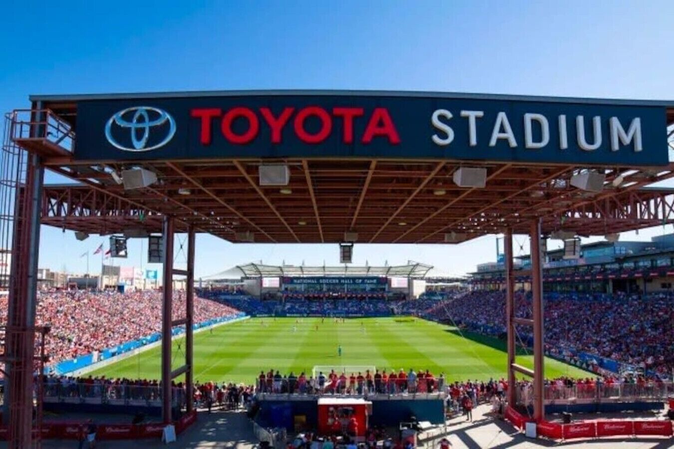 A stadium with a large crowd, a visible Toyota sign, and a green field.