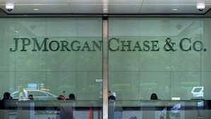 The entrance to JPMorgan Chase & Co. with a glass facade and a central door. - Elegant 2B Near Legacy West Wi-fi, Fitness, Pool (Frisco)