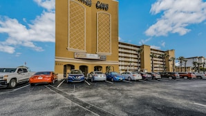 A hotel named "Pirates Cove" with a parking lot full of cars. - Pirates Cove 618 - Sunshine Serenity (Daytona Beach Shores)