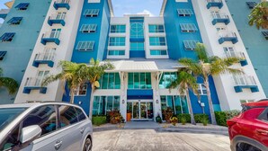 A multi-story hotel with a modern design, featuring balconies and large windows. - Coconut Palms Beach Resort 4312 (New Smyrna Beach)