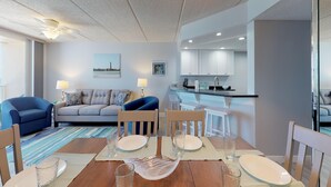 A modern hotel room with a dining area, a kitchen, and a living room. - Southpoint 303 (Ponce Inlet)