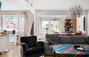A cozy living room with a sofa, a chair, a coffee table, and a bookshelf. - Gorgeous home in Oskarström with WiFi (Oskarström)