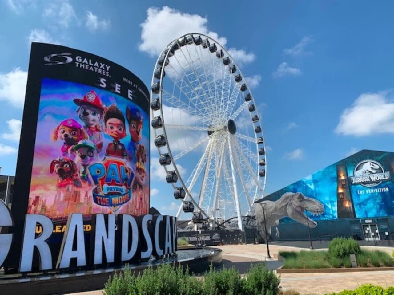 A large outdoor advertisement for 'Paw Patrol: The Movie' at a theme park.