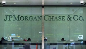 The entrance of JPMorgan Chase & Co. with a glass facade and a security camera above. - Great for Children 2 Bedroom With Bunk Beds (Frisco)