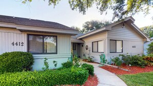 A two-story house with a front yard, a driveway, and a mailbox. - Sea Woods Villa 4412 - Villa at New Smyrna Beach (New Smyrna Beach)
