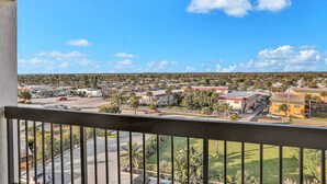 A balcony with a view of a residential area, including houses, roads, and greenery. - Ormondy A6 - Ocean Shores Getaway (Ormond Beach)